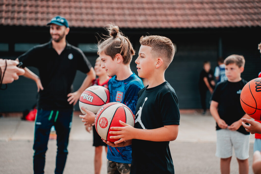 young boy holding a basketball